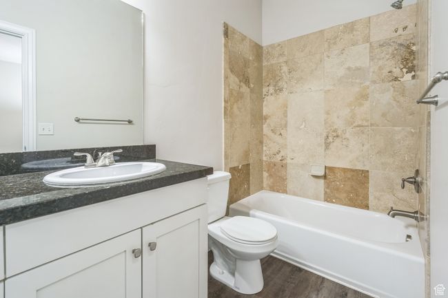 Full bathroom featuring vanity, shower / bathtub combination, and wood finished floors | Image 18