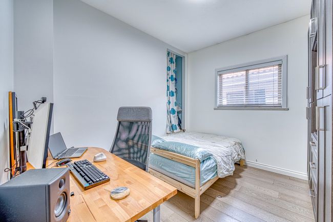 Bedroom featuring light wood-style floors and an office area | Image 13