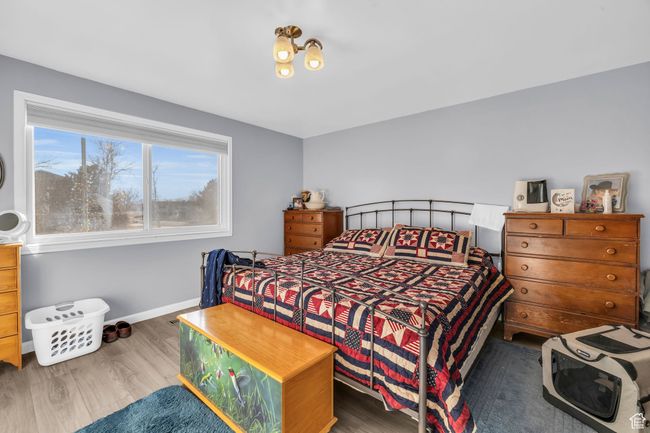 Bedroom with baseboards and wood finished floors | Image 12
