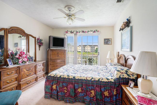 Carpeted bedroom with access to exterior, a textured ceiling, and ceiling fan | Image 19