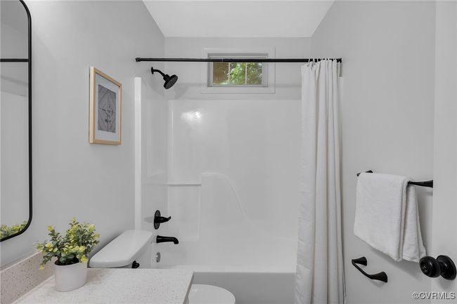 Bathroom featuring vanity, shower / bath combo with shower curtain, and toilet | Image 20