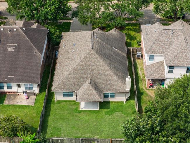 A younger 7-year-old roof with attic ridge vents and the whole house is framed by rain gutters to direct water appropriately. It's rare to find these added values at this price range. | Image 4