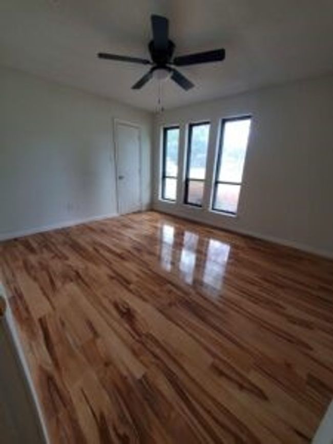 Empty room featuring wood finished floors and a ceiling fan | Image 31