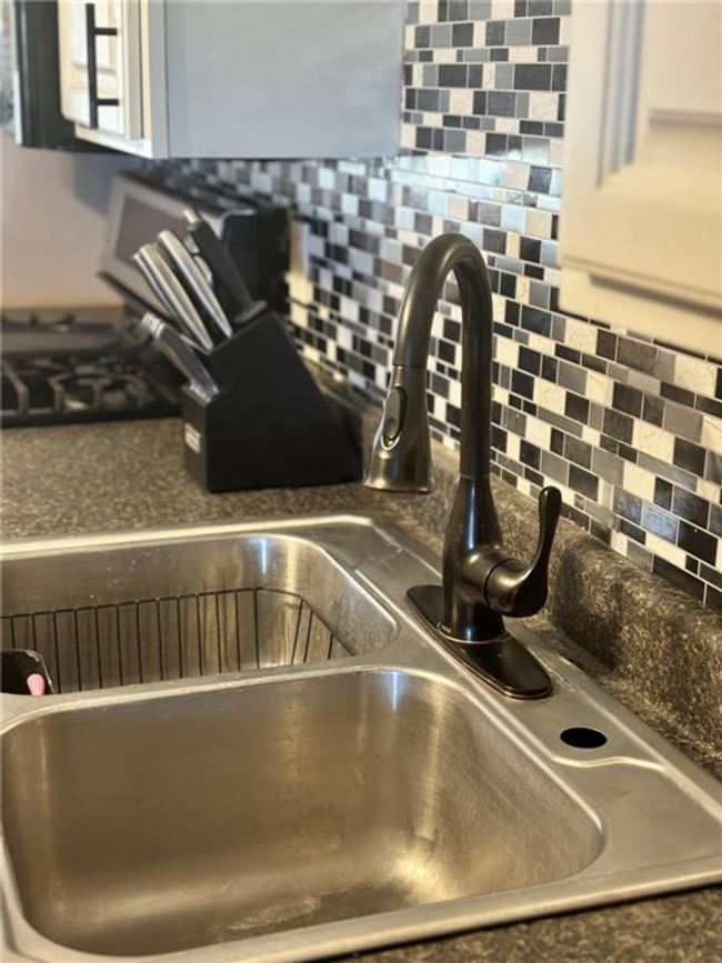 Kitchen view of a sink and backsplash | Image 13