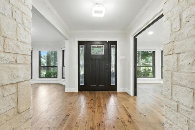 Entryway with hardwood / wood-style floors, healthy amount of natural light, and ornamental molding | Image 10