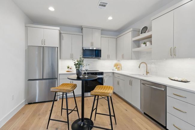 Kitchen featuring stainless steel appliances, a sink, open shelves, tasteful backsplash, and recessed lighting | Image 24