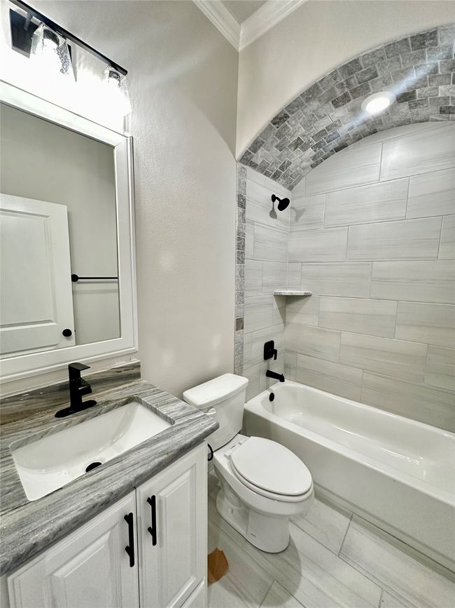 Full bathroom featuring crown molding, vanity, toilet, and shower / bathtub combination | Image 22