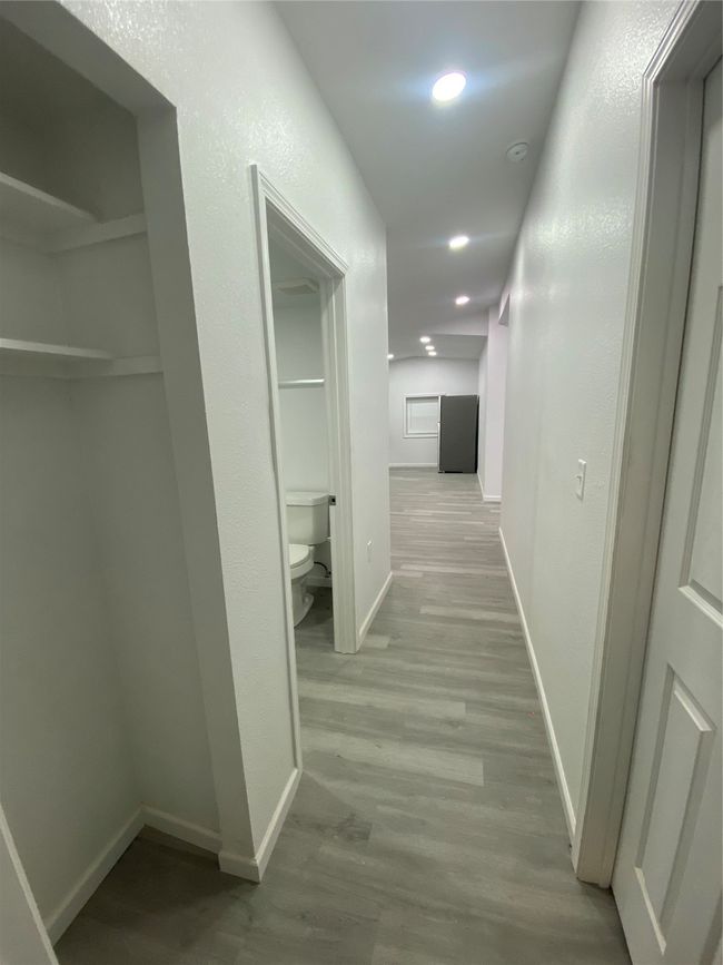 Hallway with wood finished floors, baseboards, and recessed lighting | Image 8