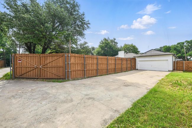 View of yard with a gate and a garage | Image 39