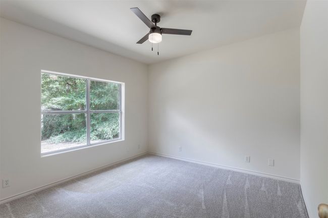 Carpeted spare room with a ceiling fan and baseboards | Image 19