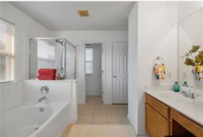 Full bathroom featuring a bath, tile patterned flooring, and vanity | Image 24