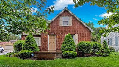 View of front of house featuring a garage and a front lawn | Image 1