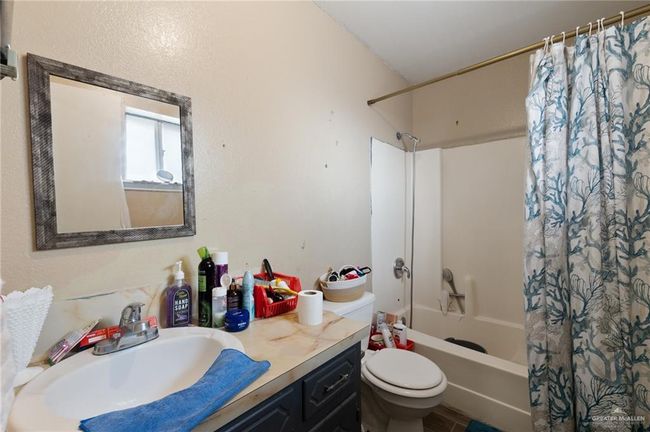 Full bathroom featuring shower / tub combo, vanity, and toilet | Image 7