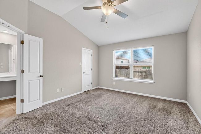 Unfurnished bedroom featuring vaulted ceiling, carpet flooring, and ceiling fan | Image 17