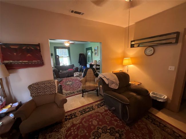 Living room with ceiling fan and wood finished floors | Image 4