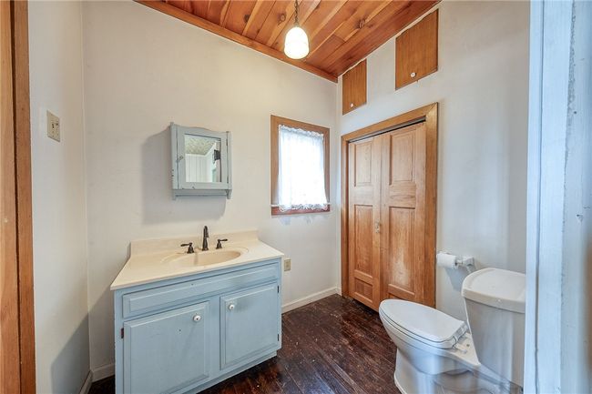 Powder room with large storage closet right off the family room on the main level | Image 17