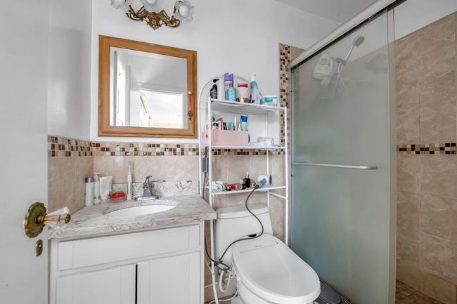 Full bath featuring tile walls, vanity, and a stall shower | Image 9