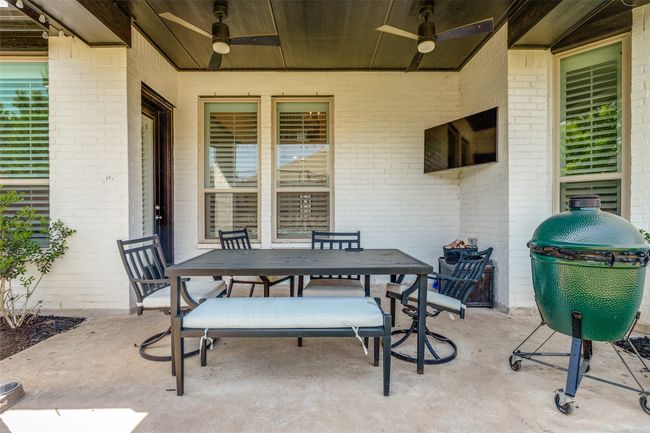 View of patio featuring a ceiling fan and outdoor dining area | Image 17