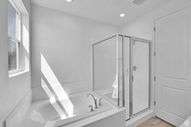 Bathroom featuring a shower stall, a bath, recessed lighting, and wood finished floors | Image 4