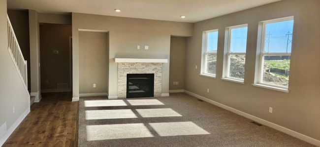 Gas fireplace with stone surround. Actual Home Shown. | Image 32