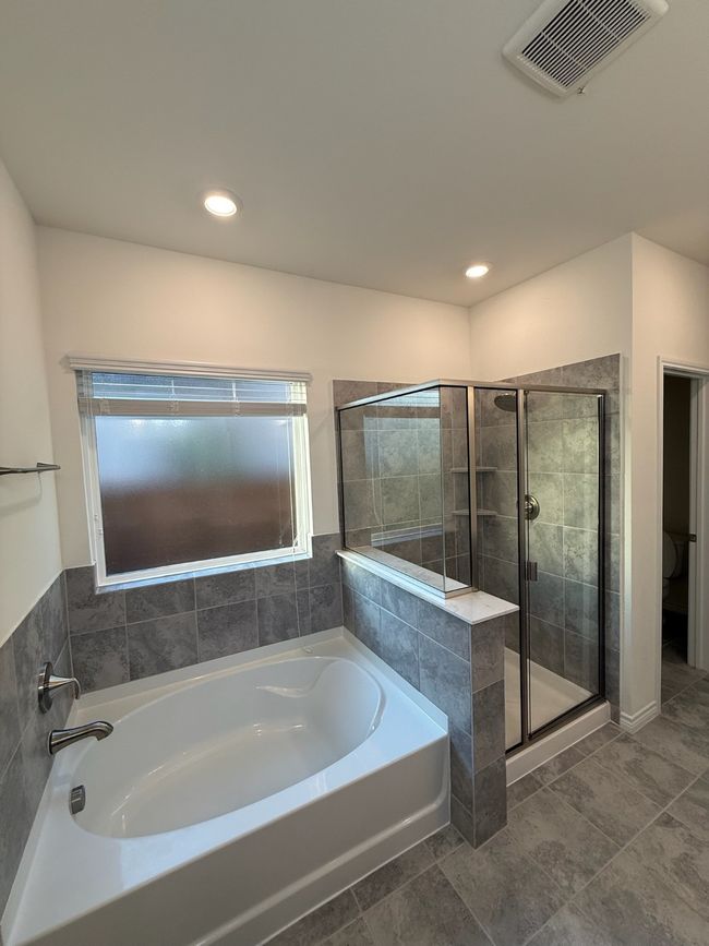 Full bath featuring a garden tub, a shower stall, tile patterned flooring, and recessed lighting | Image 14