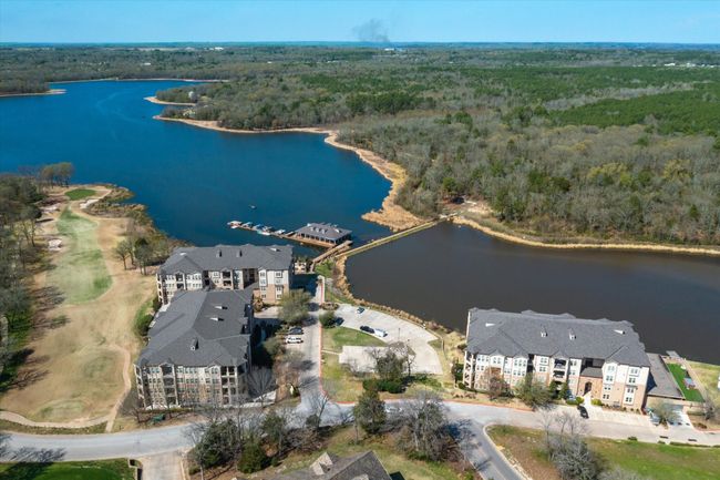 Aerial view of property's location featuring a heavily wooded area and a large body of water | Image 29