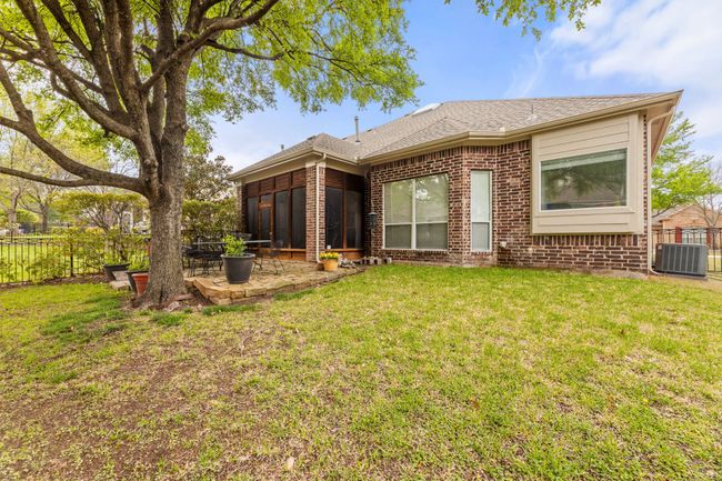 Back of property featuring fence, brick siding, a patio, central AC unit, and a lawn | Image 23