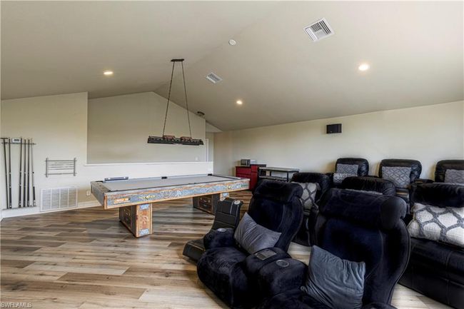 Game room with visible vents, pool table, lofted ceiling, and wood finished floors | Image 23