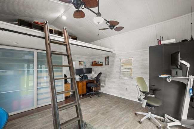 The office offers a versatile space, with plenty of room to customize, while the loft above adds an extra layer of functionality for storage or creative use | Image 29