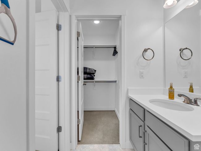 Bathroom with vanity and a walk in closet | Image 34