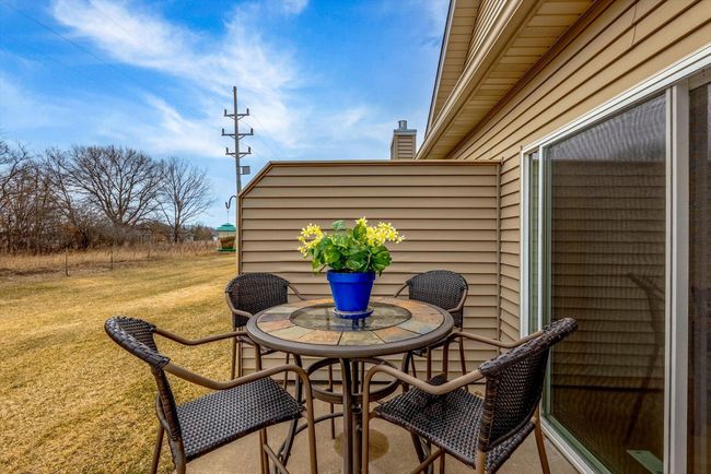 Step right off the dining room onto a private patio—perfect for relaxing or grilling, with a peaceful backyard view. | Image 19
