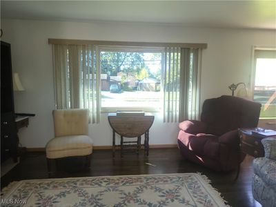 Living area with dark wood-type flooring | Image 2