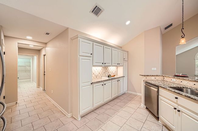 Stylish and plentiful cabinetry with "butler" style counter space | Image 9