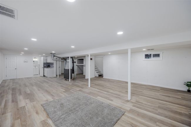Basement featuring light wood-type flooring | Image 36