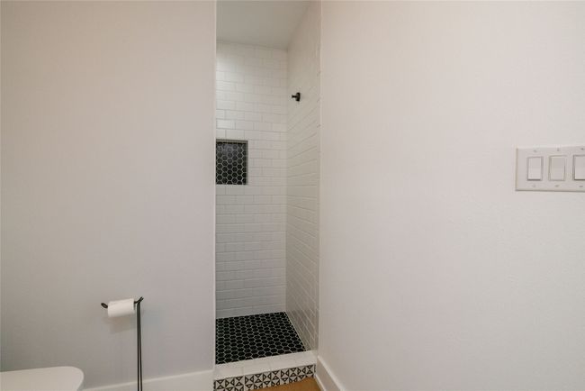 View of guest bathroom featuring a shower stall | Image 27