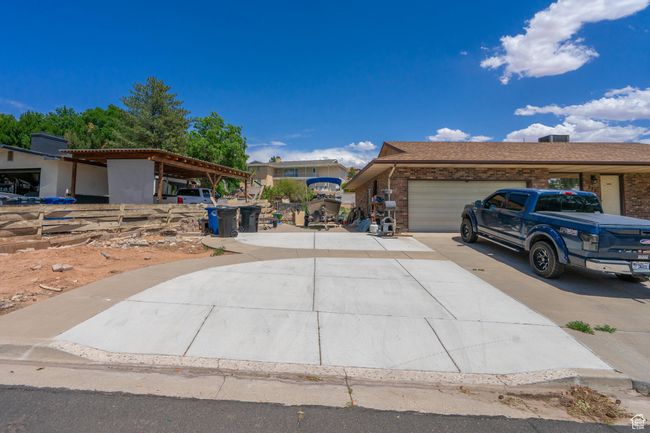 View of front of property with driveway, a garage, and brick siding | Image 4
