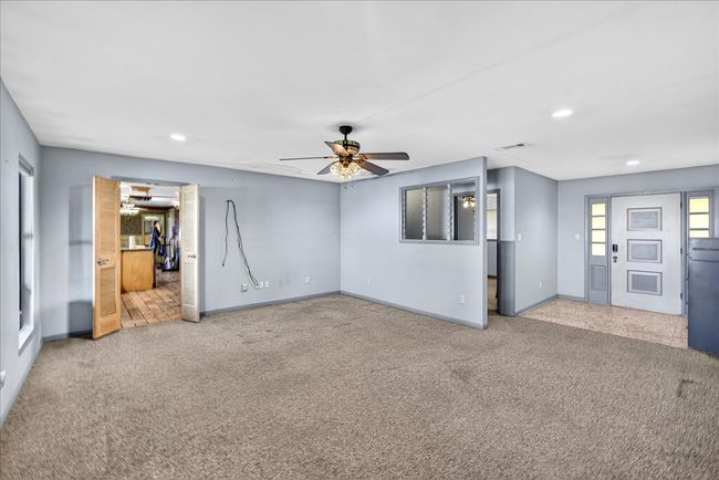 Unfurnished living room featuring carpet floors, a ceiling fan, and recessed lighting | Image 26