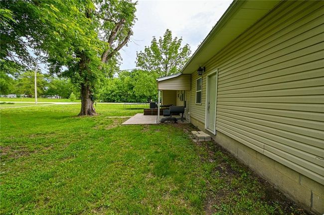 View of green lawn featuring a patio and an outdoor hangout area | Image 38