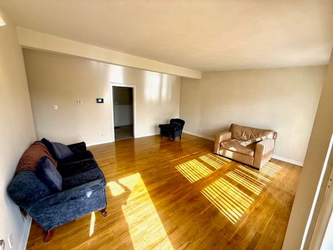 Living room featuring baseboards and wood finished floors | Image 6