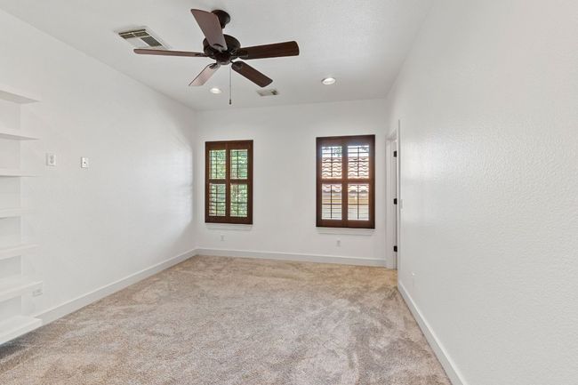 Unfurnished room featuring light colored carpet, ceiling fan, and recessed lighting | Image 21