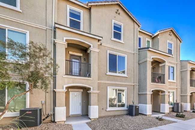 Townhome / multi-family property with stucco siding and central AC unit | Image 16