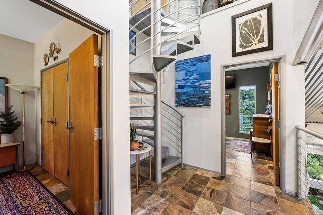 second level entrance and spiral staircase leading to third floor bedroom. | Image 30