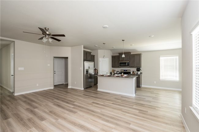 Kitchen featuring light wood-style flooring, open floor plan, and stainless steel appliances | Image 4