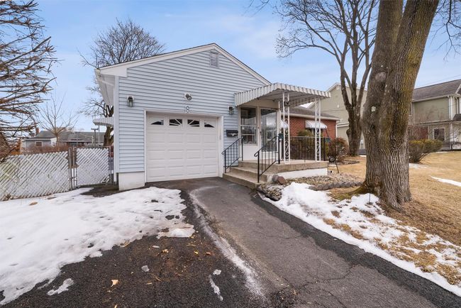 View of front of home featuring aphalt driveway, fence, and an attached garage | Image 4