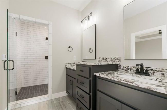 Bathroom with a stall shower, vanity, and baseboards | Image 9