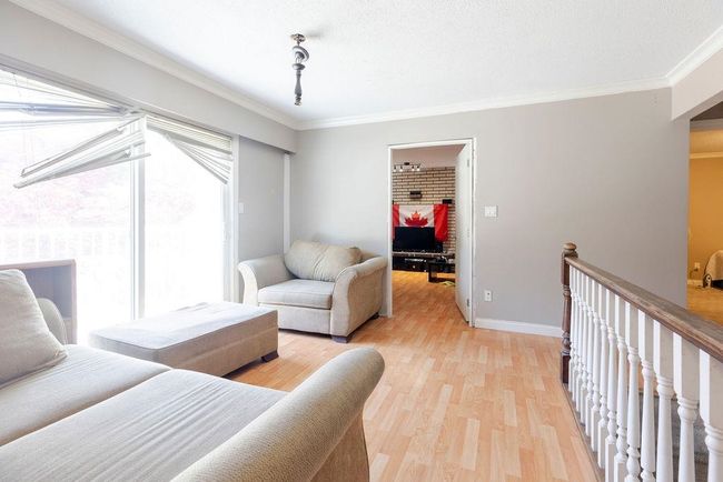 Living room featuring healthy amount of natural light, light wood-style flooring, and ornamental molding | Image 20
