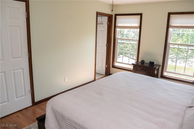 Bedroom with wood finished floors and baseboards | Image 31