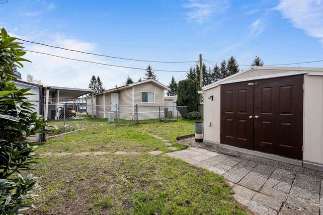 View of yard featuring an outbuilding, fence, and a storage unit | Image 27