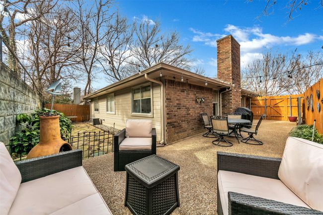 Fenced backyard with a patio | Image 29