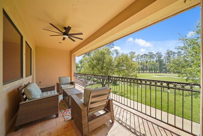 Offering space for outdoor furniture, features include recessed lighting, a ceiling fan with lighting, wrought iron railing & Saltillo tile flooring. | Image 29